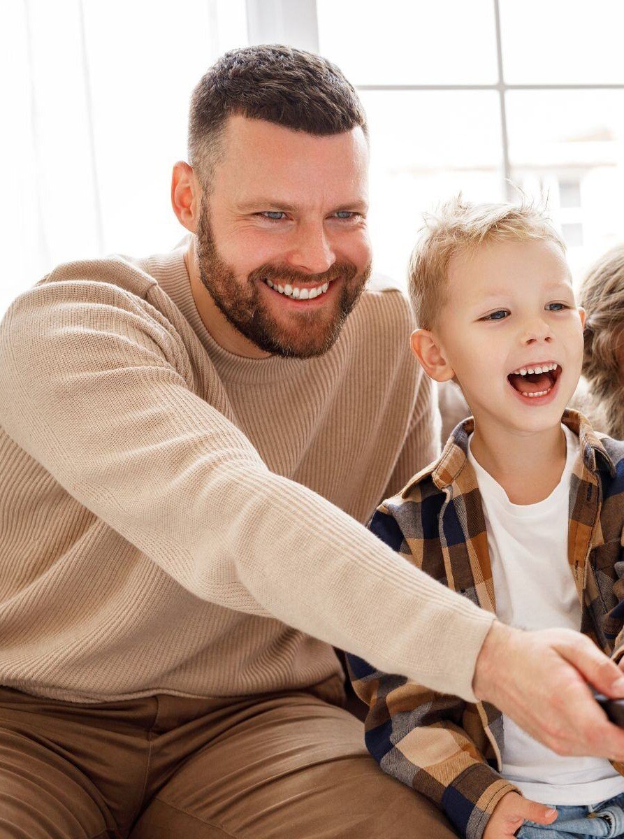 son and dad watch tv with dobson fiber internet